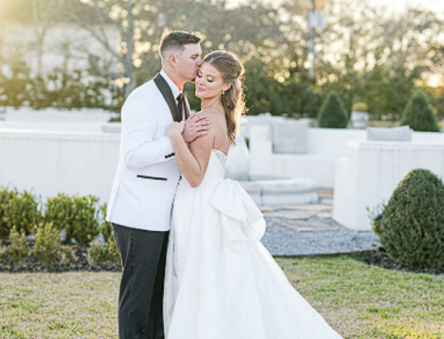 Alexis and Tristan embracing outdoors at Milicevic Farm & Vineyard Venue in Hammond, Louisiana
