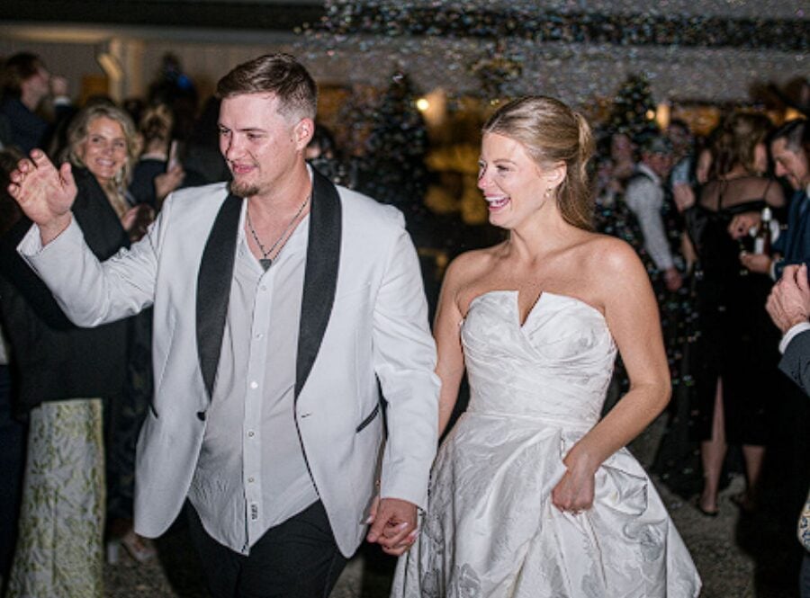 Alexis and Tristan walking through their guests at the reception