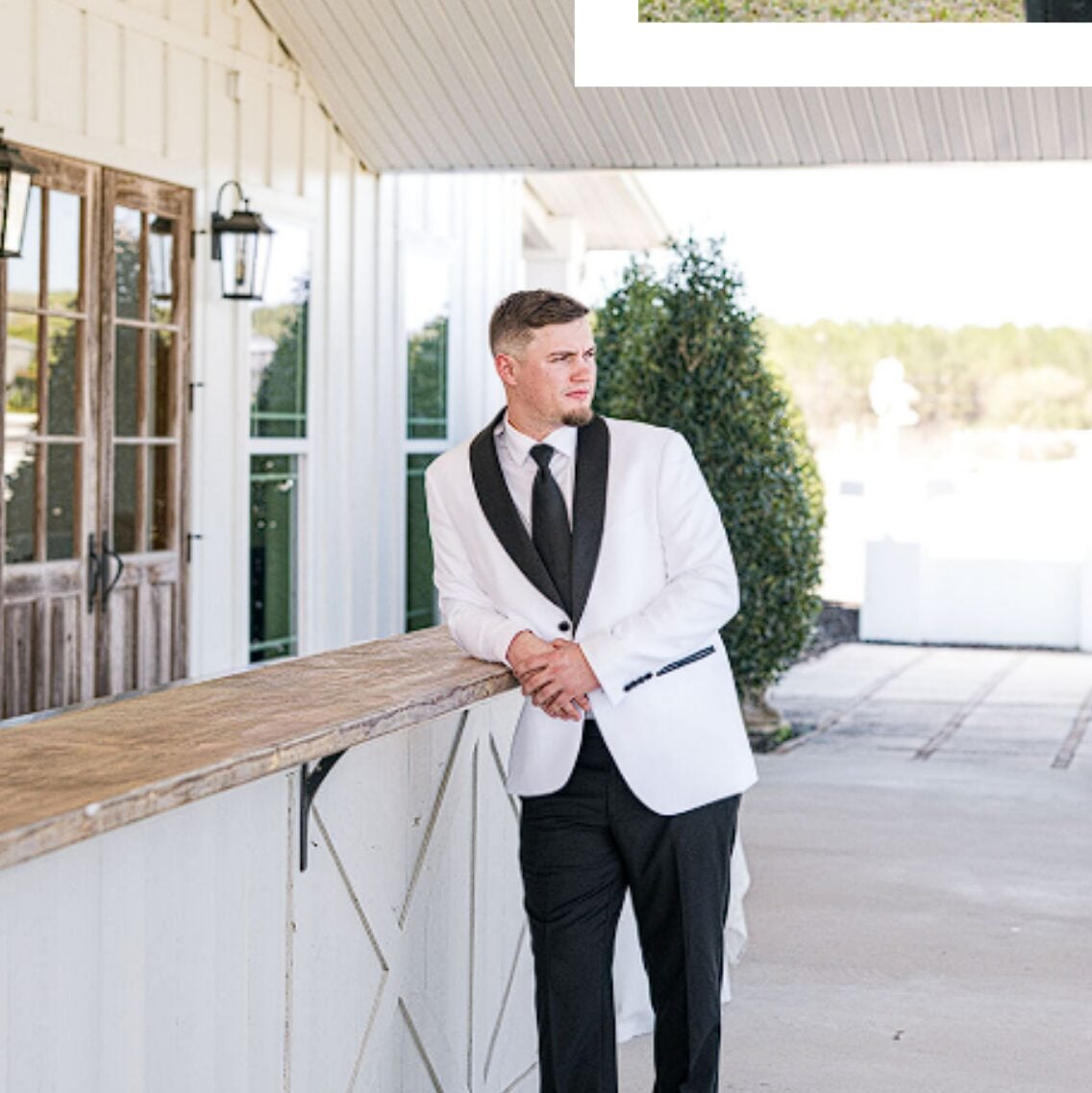 Tristan in a white dinner jacket outside the venue