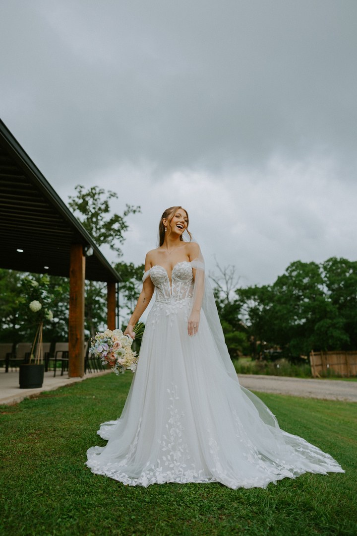 Avery in her wedding gown and veil on the lawn in Alexandria, Louisiana