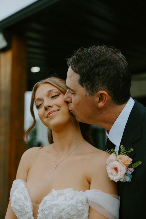 Avery sharing a tender moment with her father on her wedding day