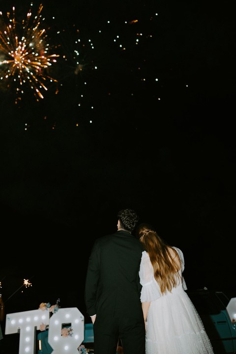 Avery and Timothy watching fireworks at the end of their wedding night