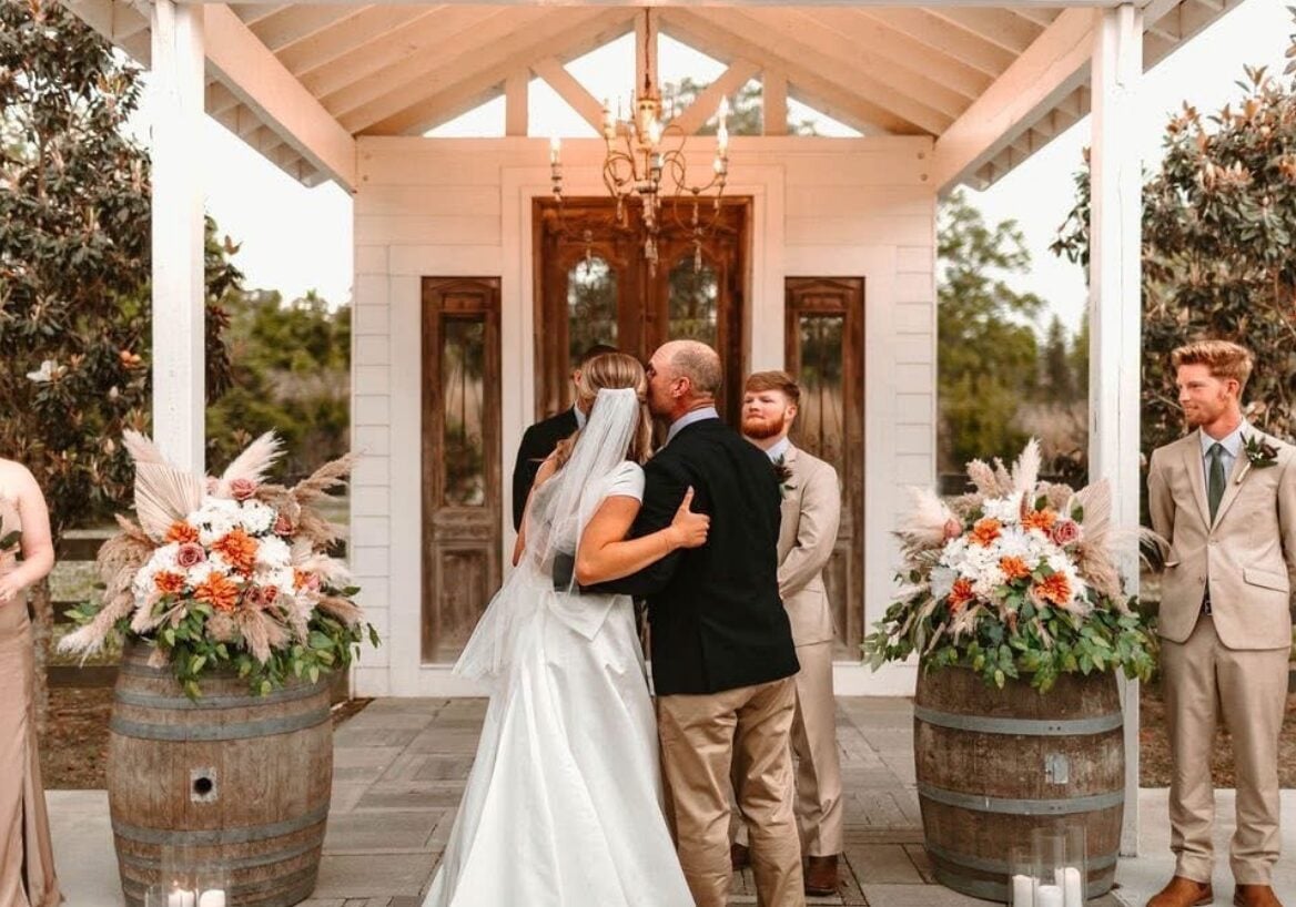 Cydney and Jaden exchanging vows during their ceremony at The Berry Barn
