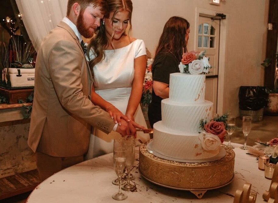 Cydney and Jaden cutting their wedding cake