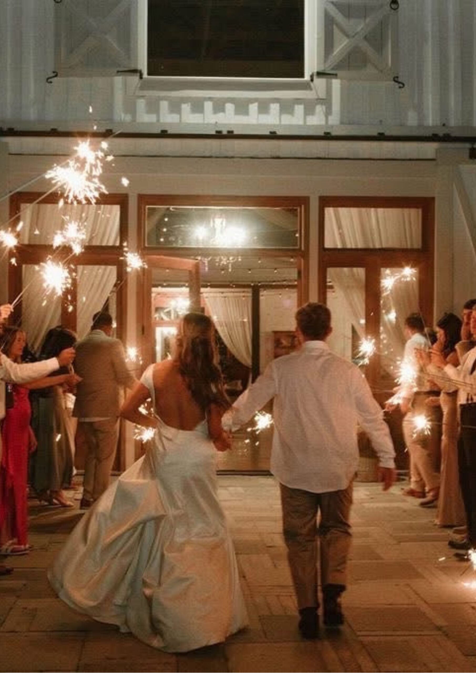 Cydney and Jaden walking through a sparkler send-off at The Berry Barn