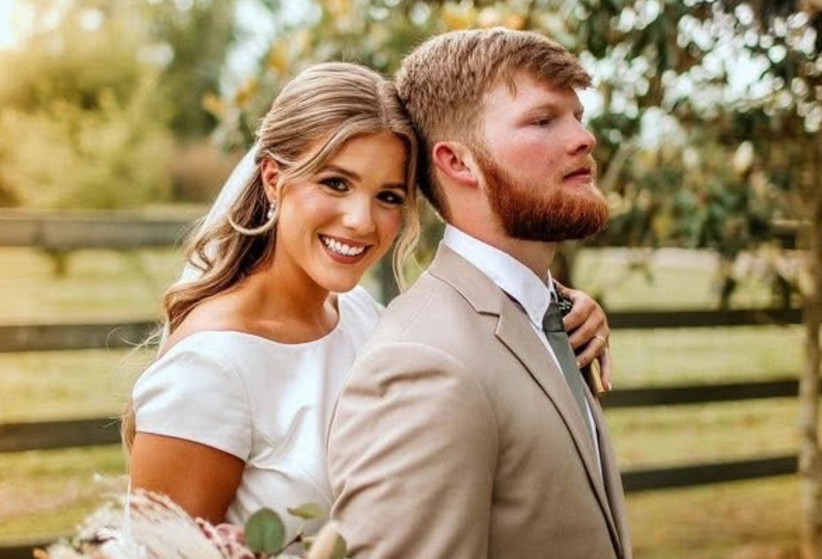 Cydney and Jaden embracing outdoors on their wedding day