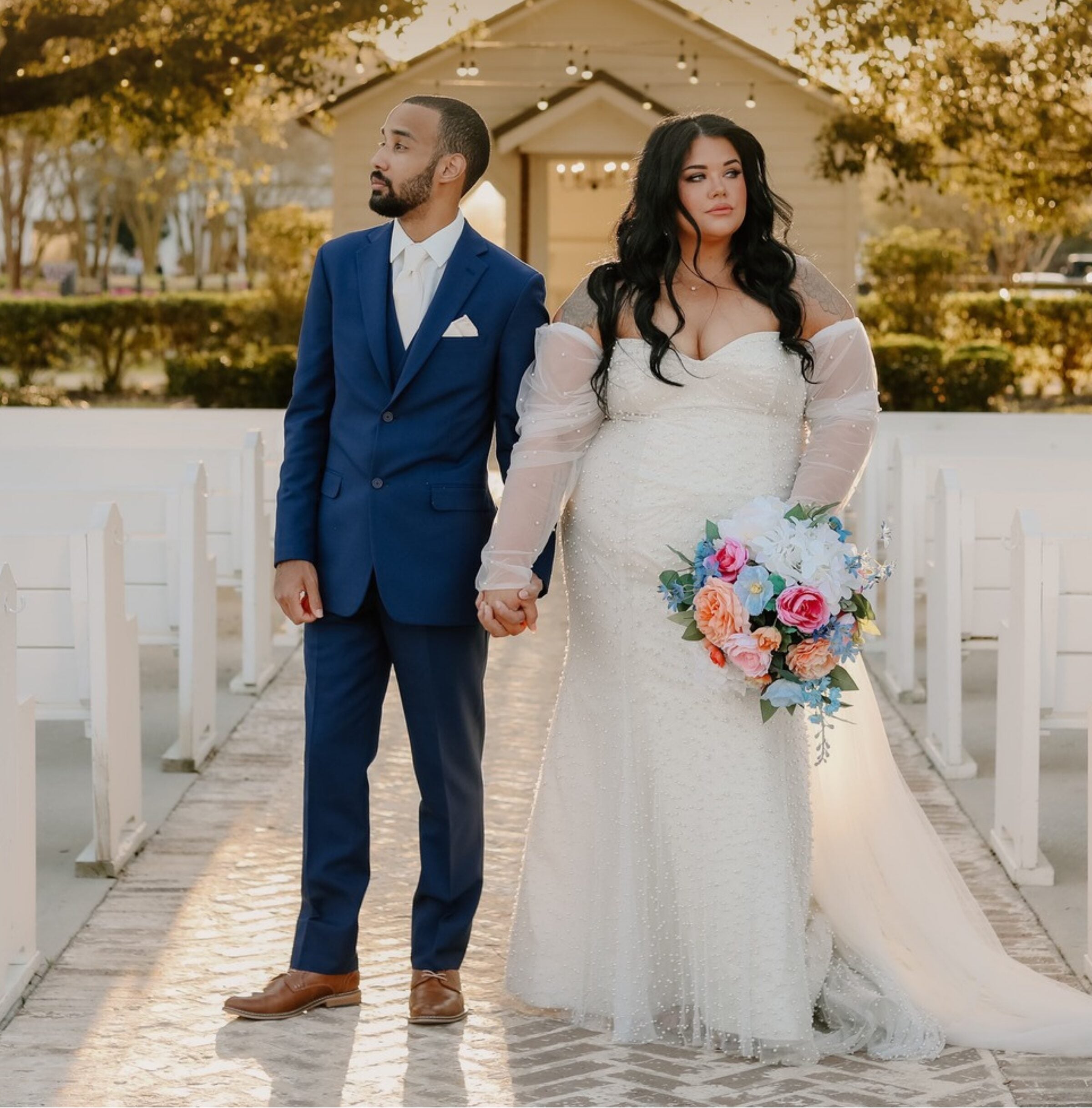 Keri and Brandon walking hand in hand at The Greenery in Louisiana