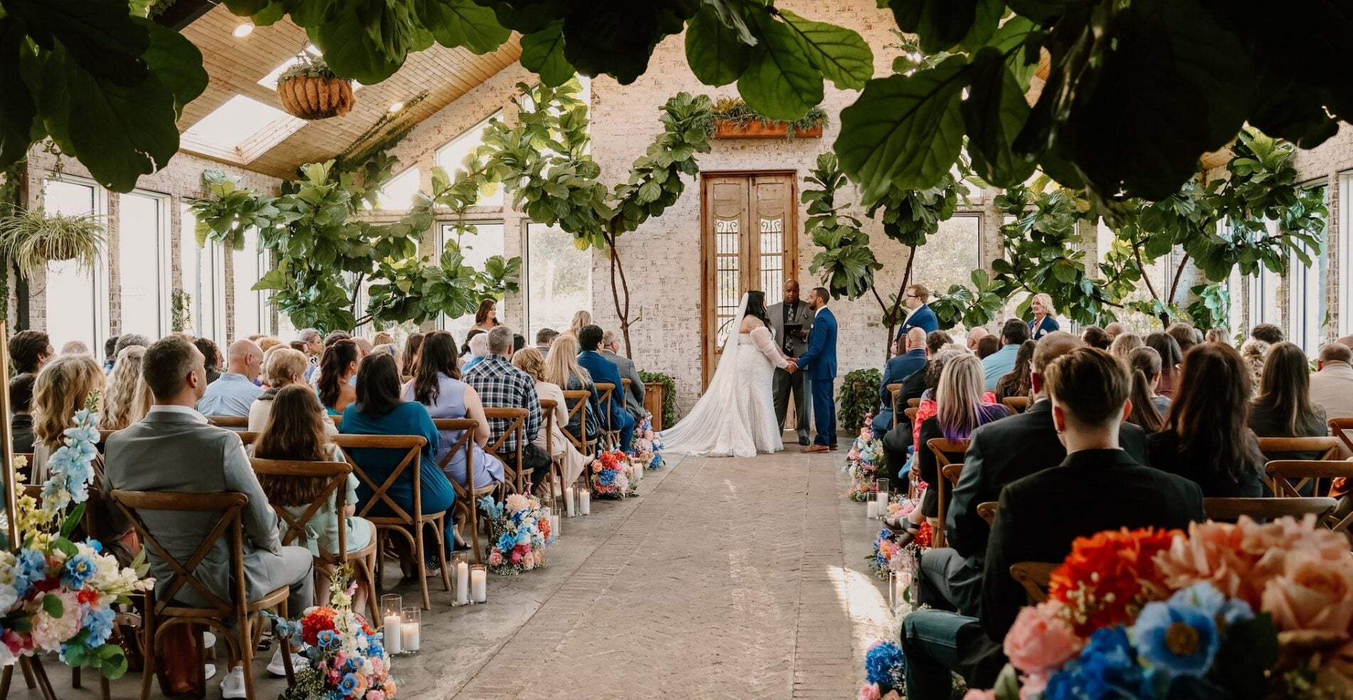 Keri and Brandon ceremony inside The Greenery surrounded by greenery