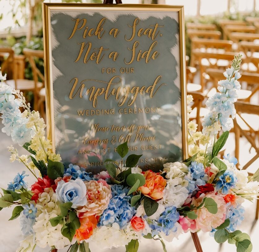 Welcome sign with blue and orange florals by Southern Made Rentals