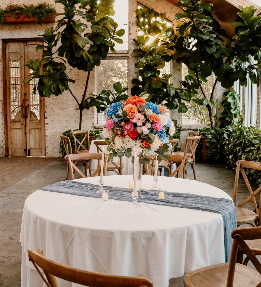 Reception table with blue and coral floral centerpiece at The Greenery