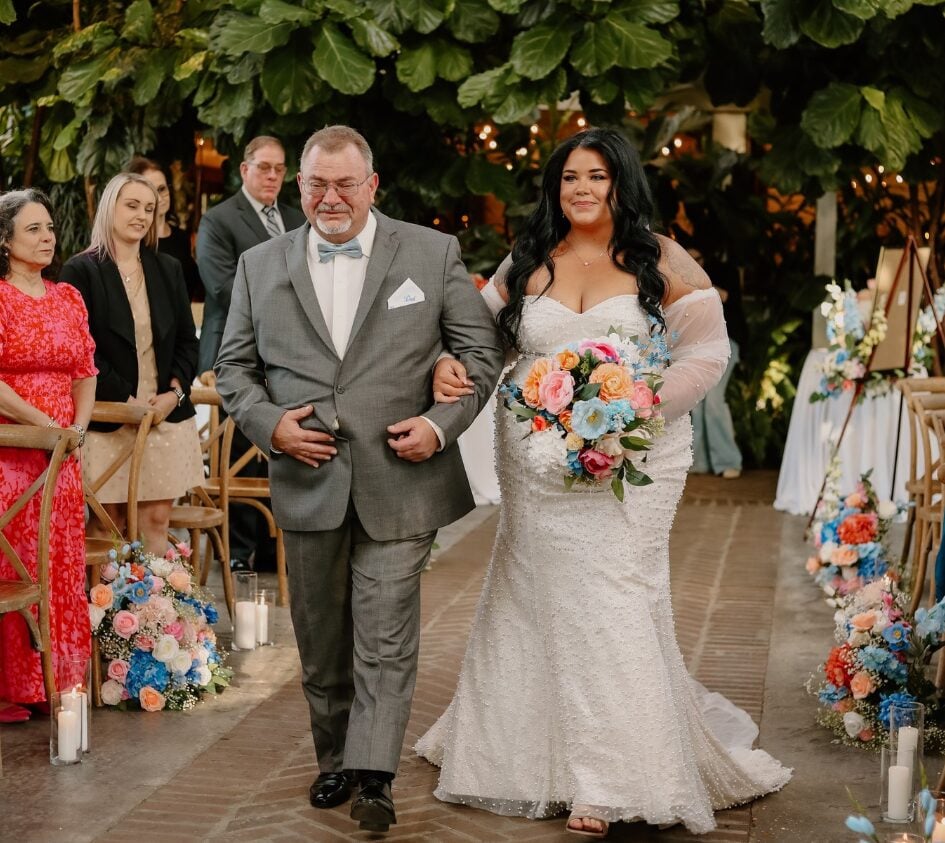 Keri walking down the aisle with her father
